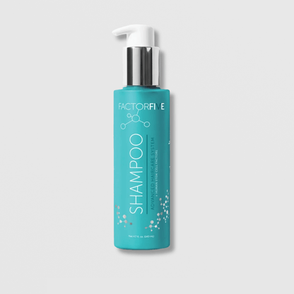 Blue shampoo bottle with white pump on a light gray background
